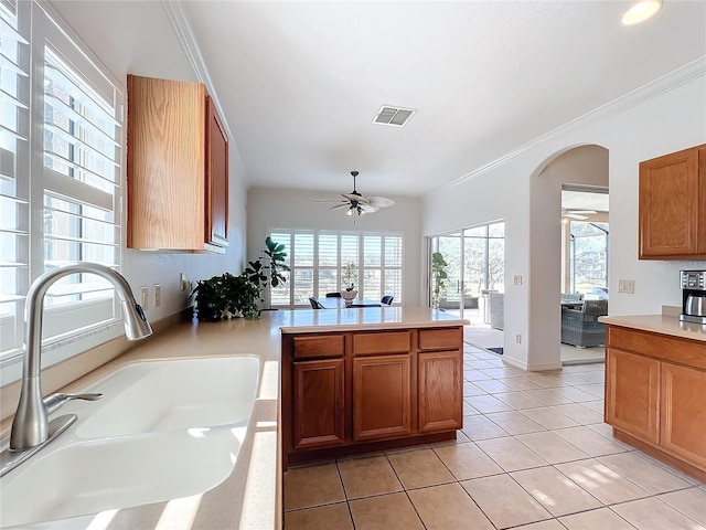 kitchen featuring sink, light tile patterned floors, plenty of natural light, and ceiling fan