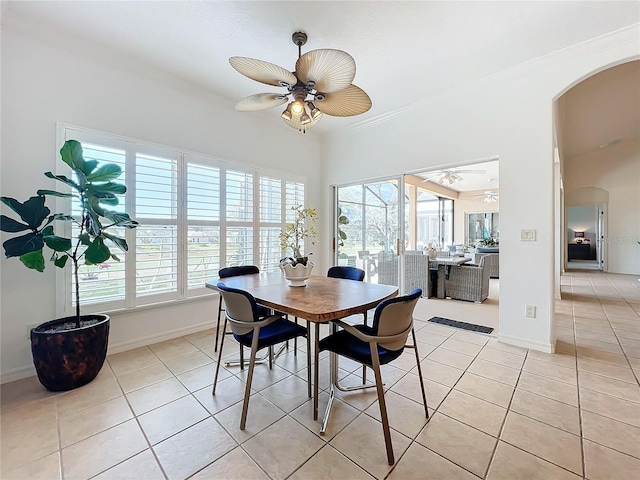 tiled dining space featuring plenty of natural light and ceiling fan