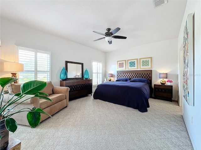 bedroom featuring light colored carpet and ceiling fan