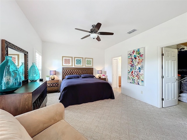 carpeted bedroom featuring ceiling fan and ensuite bath