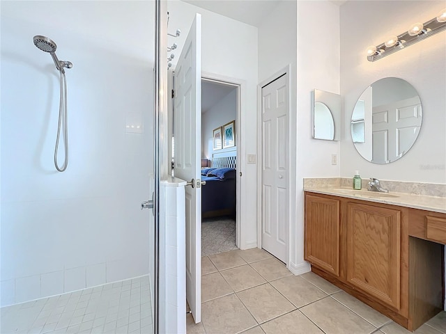 bathroom featuring vanity, tiled shower, and tile patterned floors