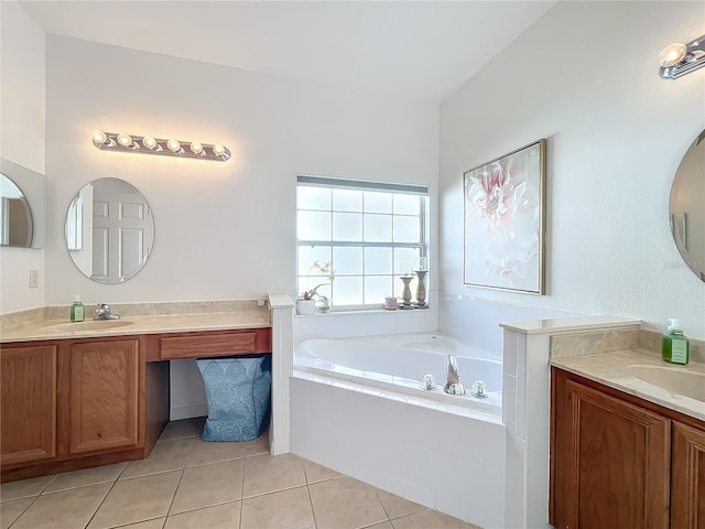 bathroom featuring a relaxing tiled tub, tile patterned floors, and vanity