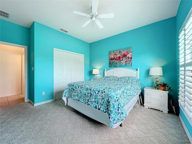 carpeted bedroom featuring ceiling fan and a closet