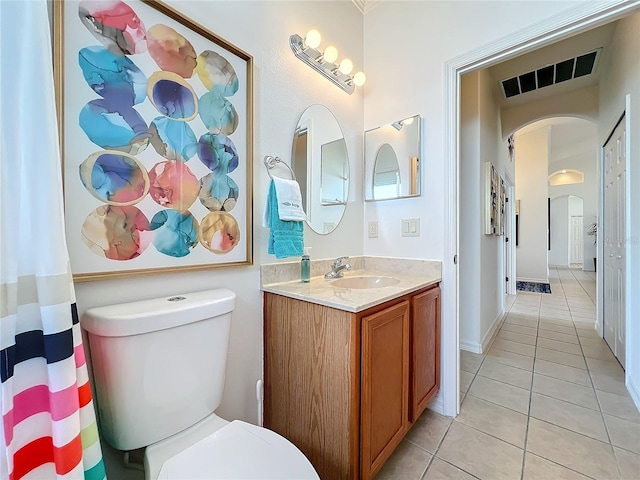 bathroom featuring tile patterned floors, toilet, and vanity