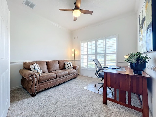 carpeted home office featuring crown molding and ceiling fan