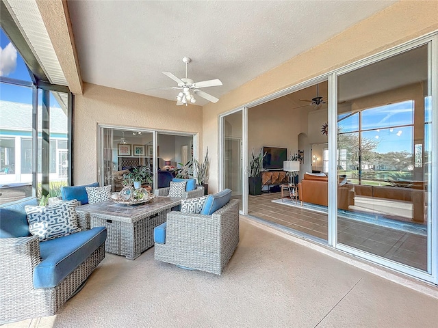 sunroom / solarium featuring plenty of natural light and ceiling fan