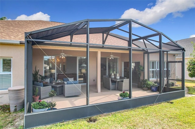 back of house featuring ceiling fan, a patio, and glass enclosure