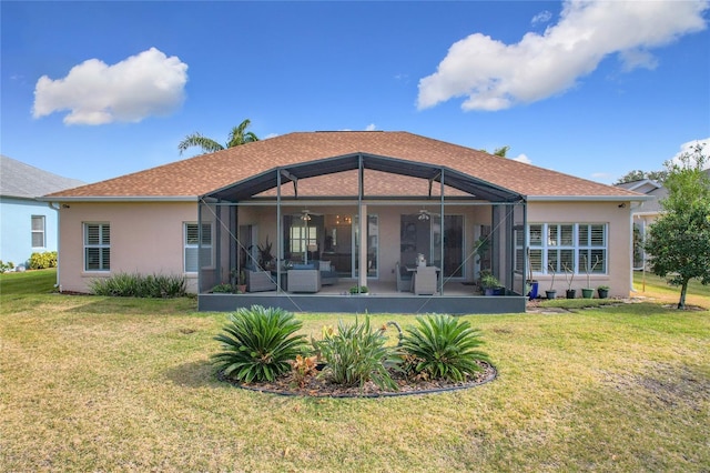 back of property with a lanai, a yard, and a patio area