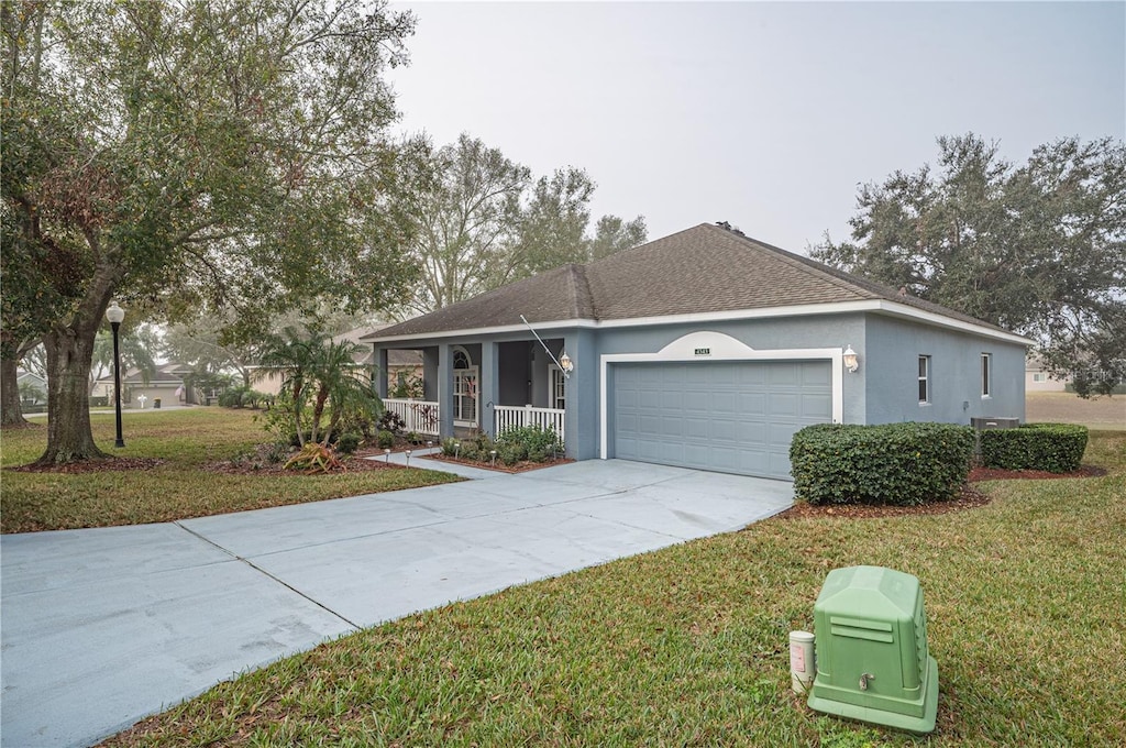 ranch-style home with a porch, a garage, and a front yard