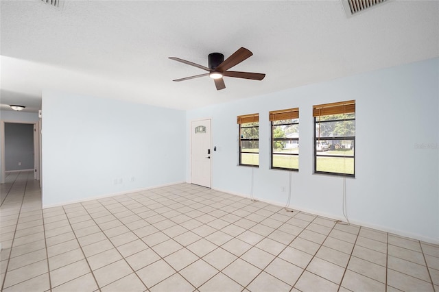 unfurnished room with a textured ceiling and ceiling fan