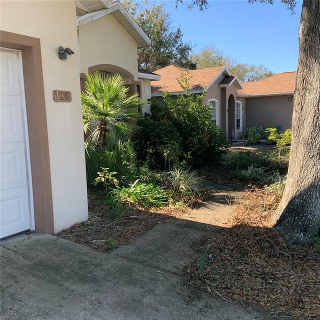 view of side of home featuring a garage