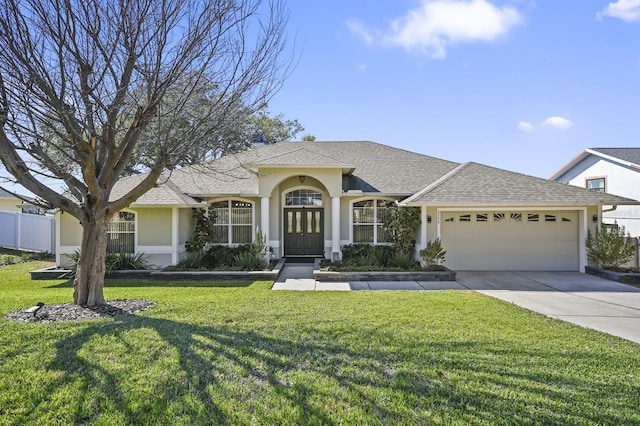 ranch-style house featuring a garage and a front yard