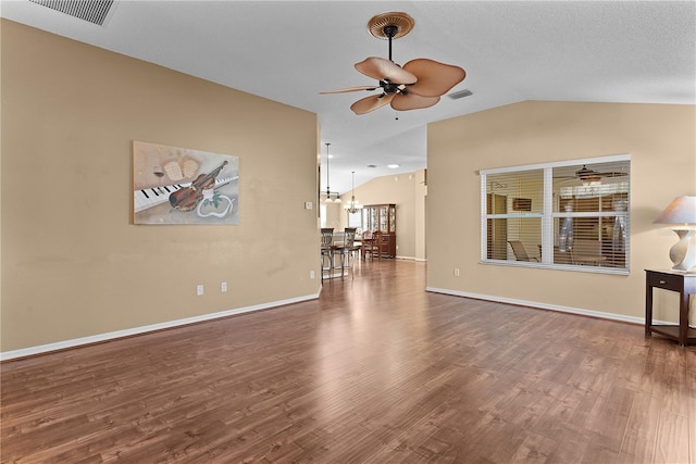 unfurnished living room featuring hardwood / wood-style flooring, lofted ceiling, ceiling fan with notable chandelier, and a textured ceiling