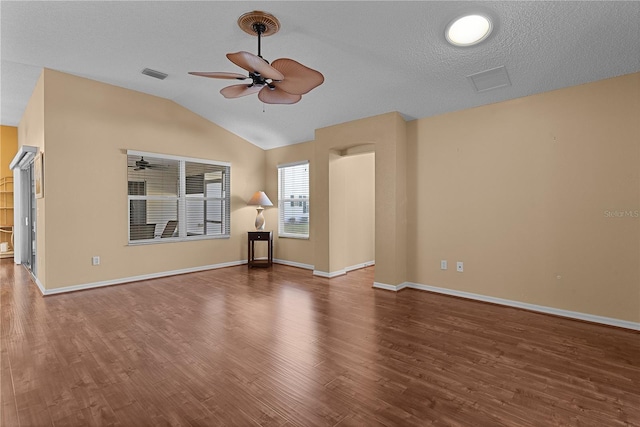 unfurnished living room featuring dark hardwood / wood-style flooring, a textured ceiling, lofted ceiling, and ceiling fan