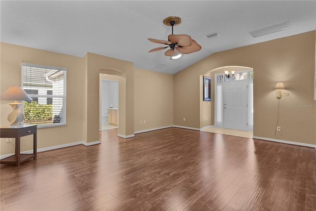 interior space with ceiling fan with notable chandelier, lofted ceiling, and hardwood / wood-style floors