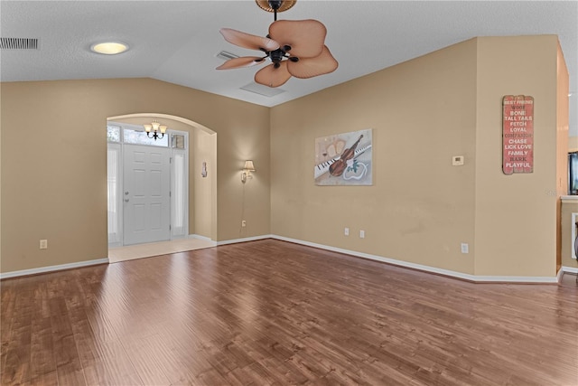 entryway with hardwood / wood-style flooring, vaulted ceiling, and ceiling fan with notable chandelier