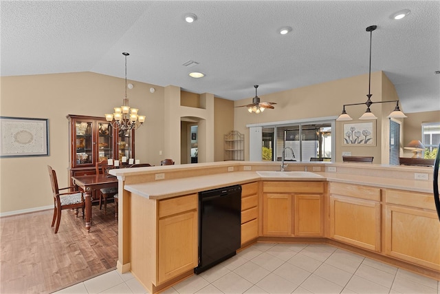 kitchen featuring sink, dishwasher, light brown cabinetry, decorative light fixtures, and vaulted ceiling