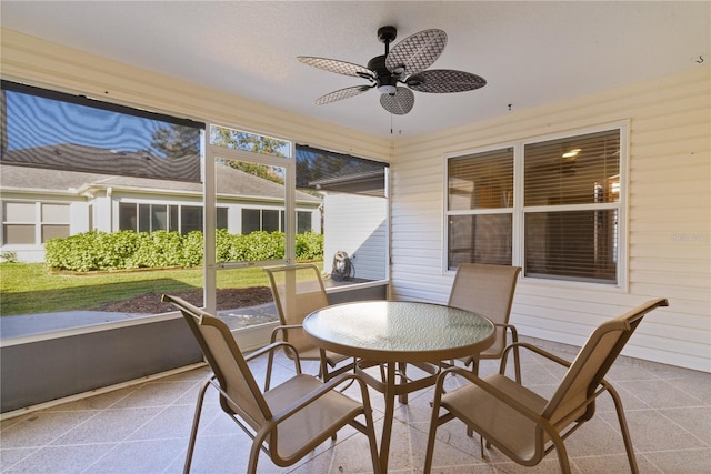 sunroom featuring ceiling fan