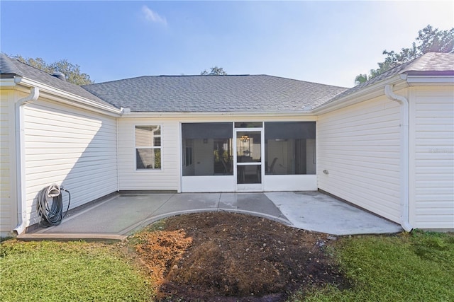 rear view of house with a sunroom and a patio area