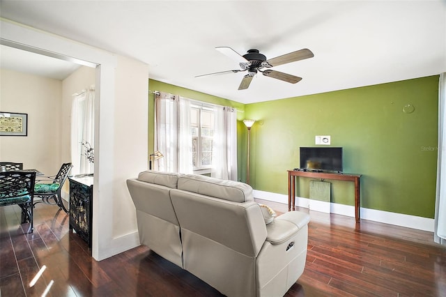 living room with ceiling fan and dark hardwood / wood-style flooring