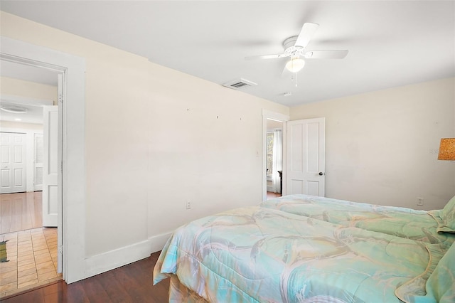 bedroom with dark wood-type flooring and ceiling fan