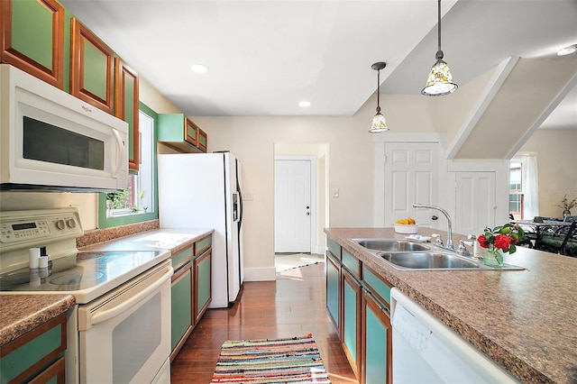 kitchen featuring sink, pendant lighting, white appliances, and dark wood-type flooring