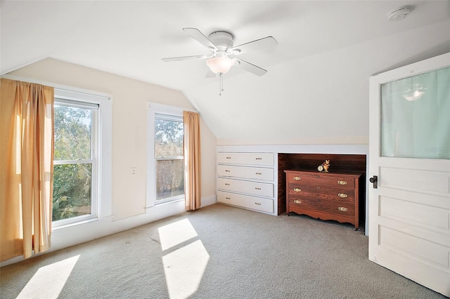 additional living space featuring lofted ceiling, light colored carpet, and ceiling fan