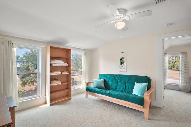 living room featuring ceiling fan, light colored carpet, and vaulted ceiling