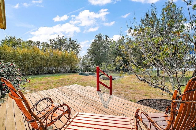 wooden terrace featuring a lawn