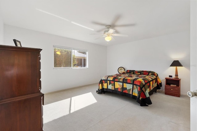 bedroom featuring light carpet and ceiling fan