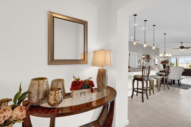 dining room featuring an inviting chandelier, light tile patterned flooring, and sink