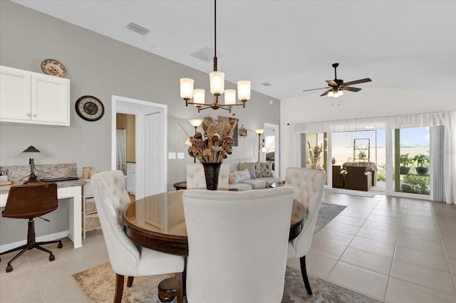 tiled dining room featuring lofted ceiling and ceiling fan with notable chandelier