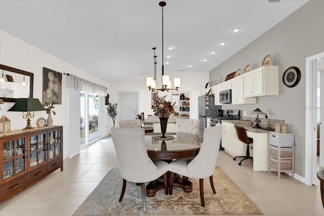 tiled dining room with vaulted ceiling and a notable chandelier