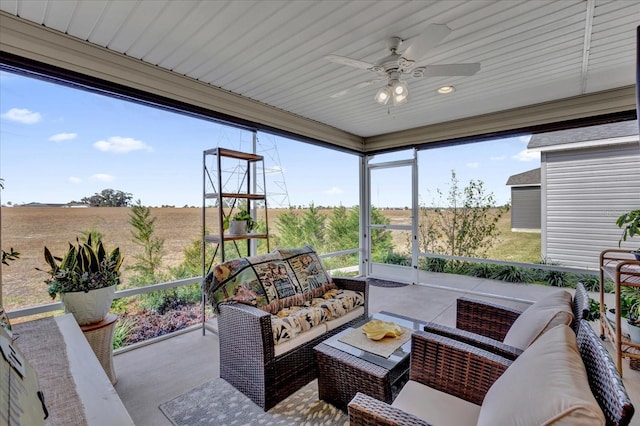 view of patio with an outdoor living space, a rural view, and ceiling fan