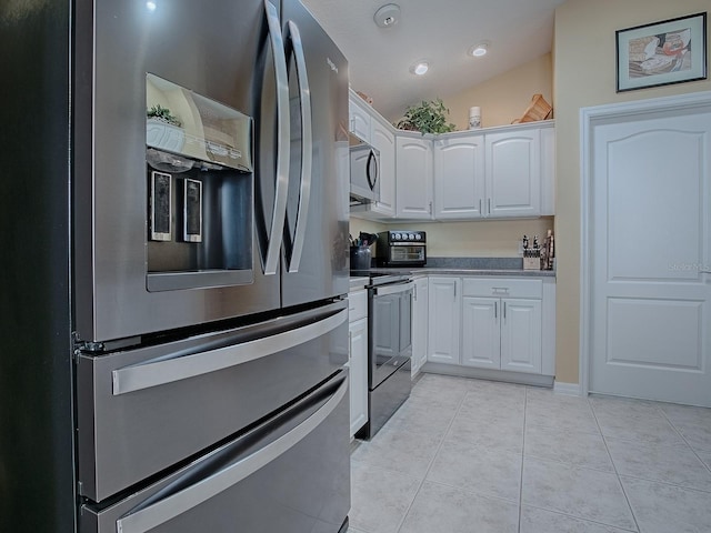 kitchen with white cabinetry, light tile patterned floors, vaulted ceiling, and appliances with stainless steel finishes