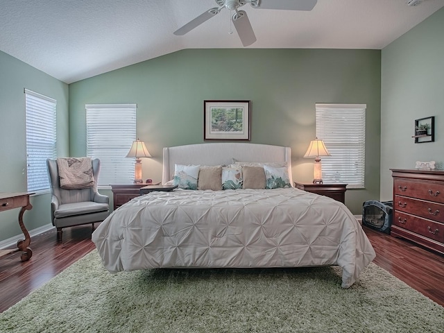 bedroom with ceiling fan, lofted ceiling, and dark hardwood / wood-style flooring