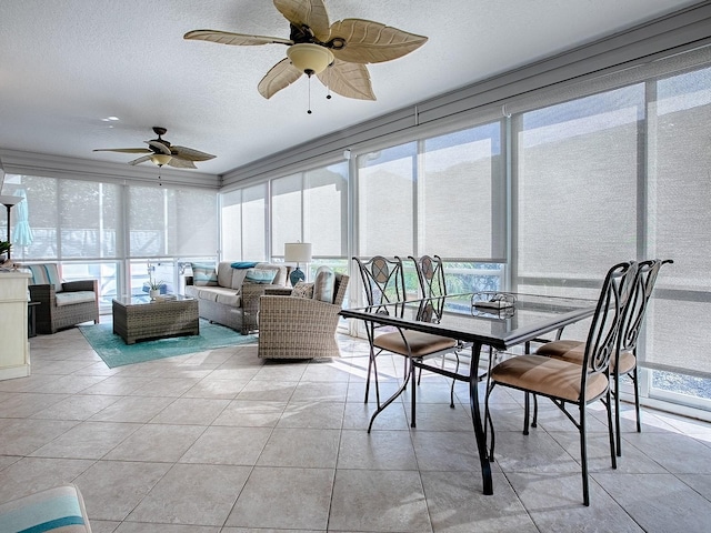 sunroom featuring ceiling fan and a healthy amount of sunlight