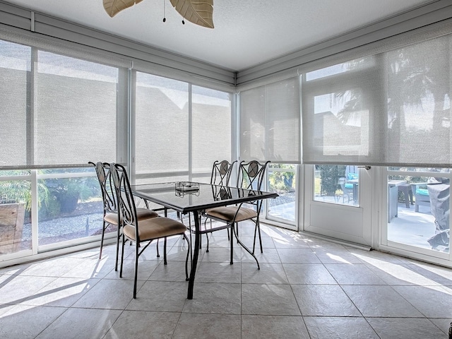 sunroom / solarium featuring ceiling fan