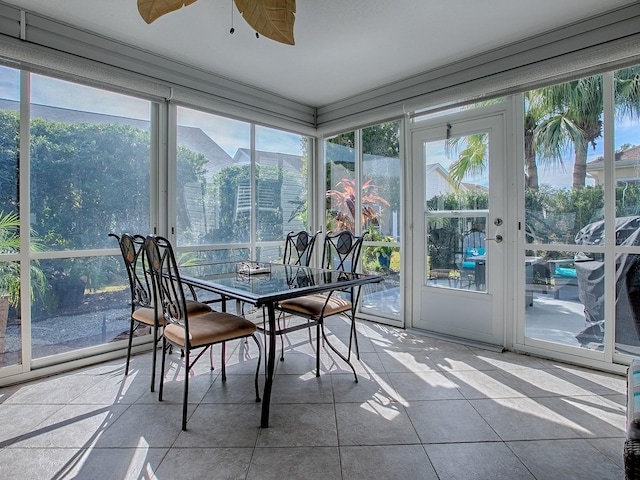 sunroom with a wealth of natural light and ceiling fan