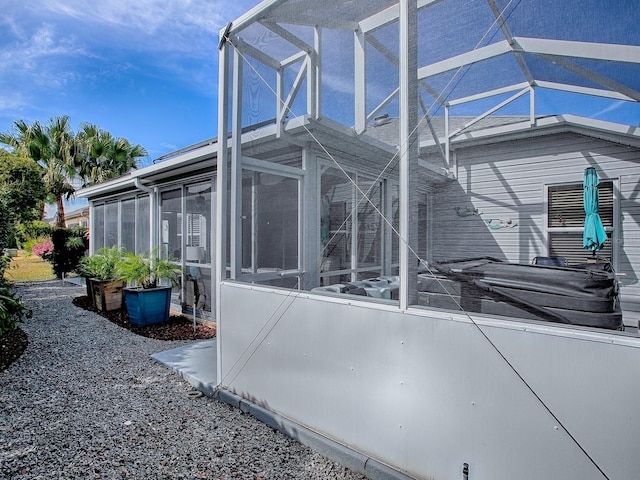 view of property exterior featuring glass enclosure