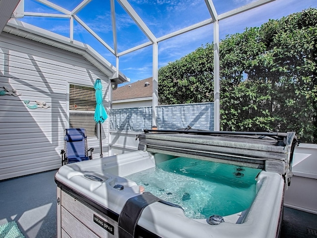 view of patio featuring a lanai and a hot tub