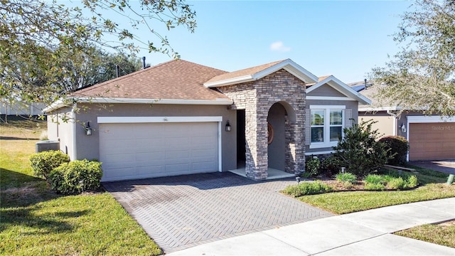 view of front of property with a garage and a front lawn