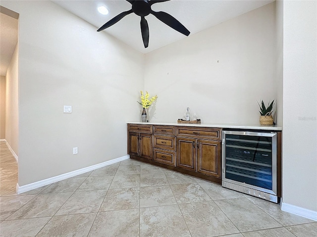 bar featuring wine cooler, light tile patterned floors, and ceiling fan