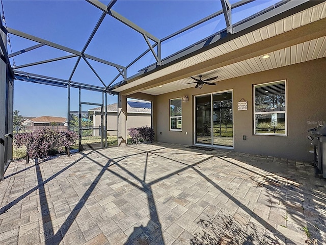 view of patio / terrace with ceiling fan and a lanai