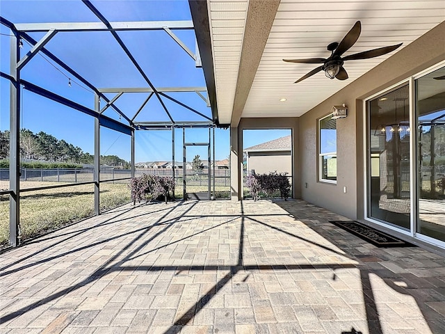 view of patio / terrace featuring ceiling fan and a lanai