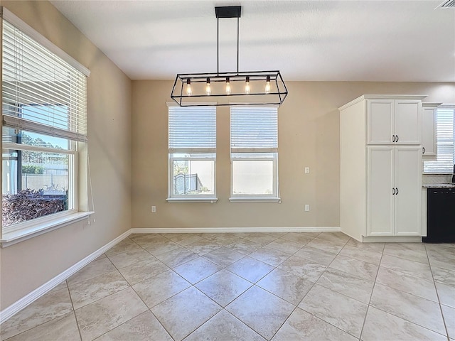 unfurnished dining area with light tile patterned flooring