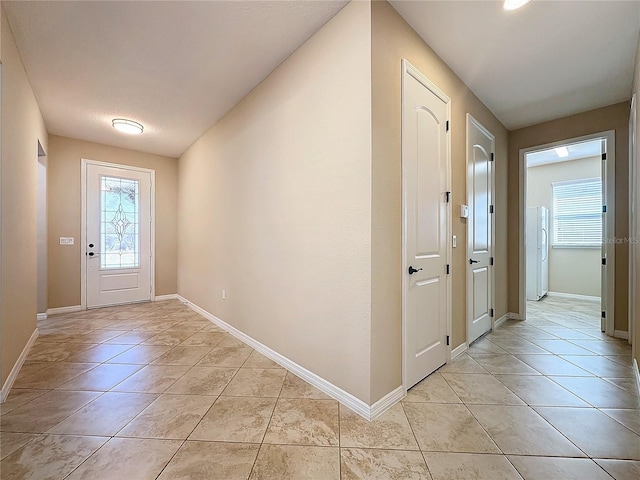 doorway to outside featuring light tile patterned flooring