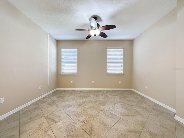 tiled spare room with ceiling fan and a textured ceiling