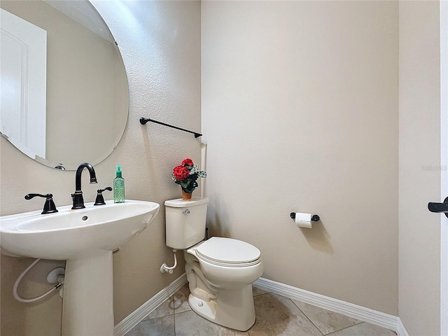 bathroom featuring tile patterned flooring and toilet