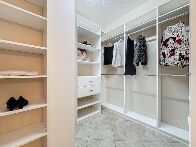 walk in closet with tile patterned flooring